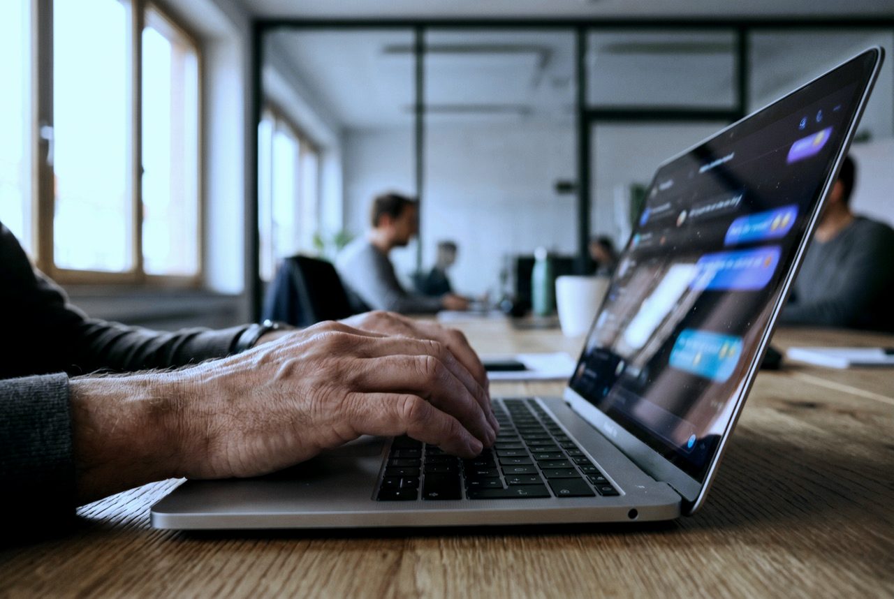 Hände am Laptop, Chat-Bubbles auf dem Bildschirm